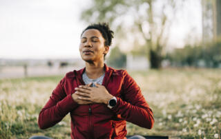 African American female outdoor, in nature and being calm for breathing exercise and health