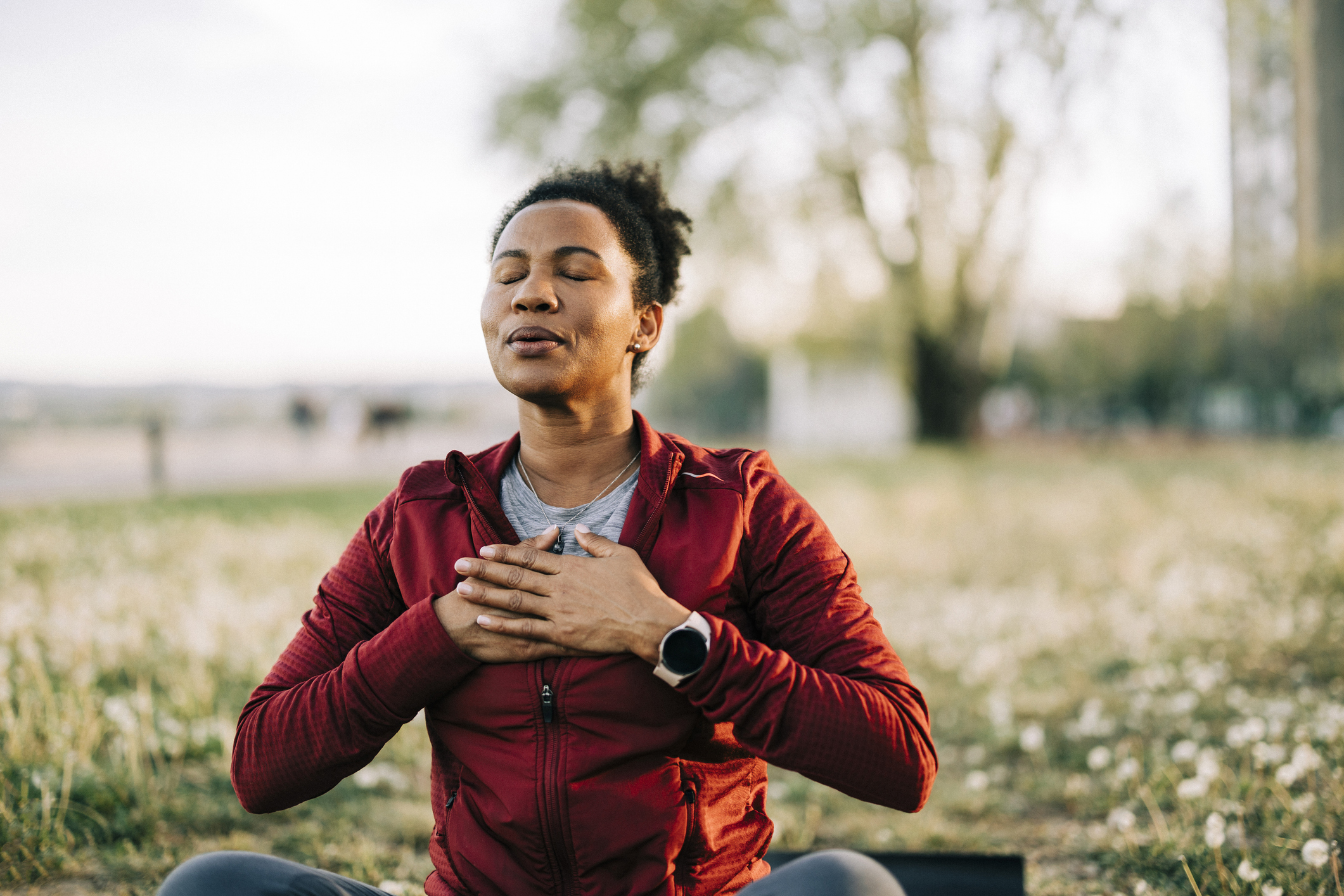 African American female outdoor, in nature and being calm for breathing exercise and health